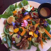 Garden greens salad with flowers and fig and dates at Sweet Potato Kitchen in Hawi