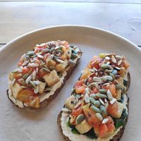 Toast with cashew cream cheese, tofu, tomatoes, spinach and nuts at Meori in Arugam Bay
