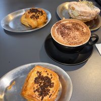Ham and cheese pastry, hot chocolate, girello pistachio at the back right   at The Sanctuary - PBerg in Berlin