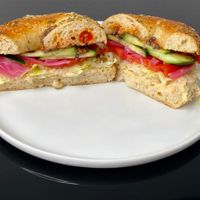 Mediterranean sandwich (minus feta) on a rosemary sea salt bagel (plated at home) at Bloom Bistro & Grocery in Seattle
