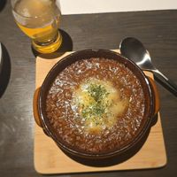 Grilled potatoes with soy meat keema and soy cheese, and a beer at Cafe & Bar Oku in Kyoto
