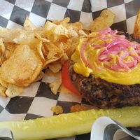 Honemade black bean burger w/lettuce, tomato, cashew cheese sauce, & pickled red onions. Comes with cajun chips. at Burn 'Em Brewing in Michigan City