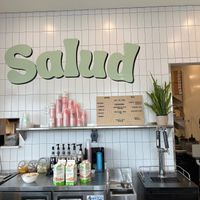 Salud sign behind the register with their coffee and tea menu at Salud in Portsmouth