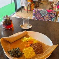 Vegan mixed plate and special black tea with cinnamon and cloves at Habesha Äthiopisches-Ethiopian and Eritrean-African Cuisine Restaurant Café & Bar in Salzburg