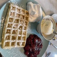 Waffle with vanilla ice cream, whipped cream and cherries   at Cafe Hibiskus in Cologne
