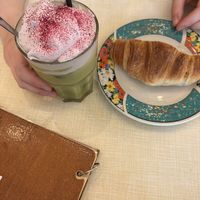 Croissant und iced ube matcha  at Cafe Rotkehlchen - Venloer Str in Cologne