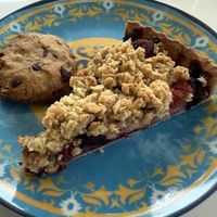 Apple crumble with red berries and a cookie   at Canela in Bruges