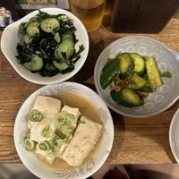 Simmered tofu, seaweed salad, spicy pickled cucumbers  at Yakitori Bunraku in Tokyo