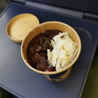 Porridge with dark chocolate chips, coconut flakes and berries at Haferkater - Hbf in Munich