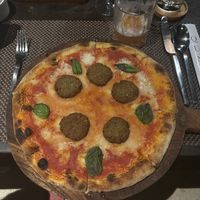 Vegan pizza! They didn’t have the vegan sausage so replaced with falafel. They were super accommodating   at Quali Asian Dining at Qunci Villas in 
