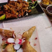 Bhaji & Samosas. Side dishes included (untouched) raita. at Le Taj Mahal in Saint-gervais-les-bains