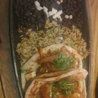 Vegan Chick’n Tacos (2):
Signature tortillas filled with marinated vegan chick’n, charred tomato salsa, caramelized chipotle onions. Served with black beans & wild rice. at Nacho Daddy - Downtown in Las Vegas