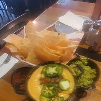VEGAN TRIPLE DIP (GF): Guacamole, house-made vegan queso, salsa & chips. at Nacho Daddy - Downtown in Las Vegas