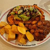 Avo on sourdough with harissa beans and homestyle potatoes at The Breakfast Club - Seven Dials in London