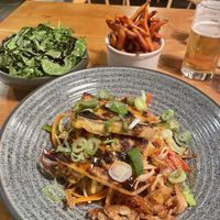 Spicy Tofu stir fry with leaves and sweet potato chips  at The Lime Tree in Bollington