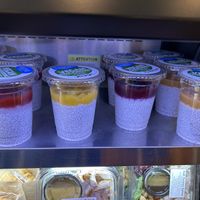 Multiple flavors of vegan chia pudding in the cold case  at Parva Coffee in Jackson Heights
