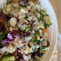  Salad bowl with supergreens, red pepper hummus, falafel, cabbage slaw, cucumbers, tomato/cucumber salad, olives and lemon herb dressing at CAVA in College Station