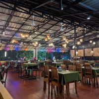 Rooftop/upper floor with view on trees, street and beach/sea at Kiran Kitchen Restaurant in Ao Nang