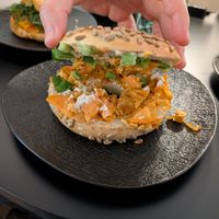 Bagel Breaking bad with cashew cream, sweet potato crunch and spring onions. at GegenVind Café in Hamburg