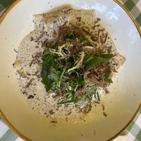 Rich, creamy vegan truffle ravioli topped with fresh herbs and shavings of truffle—an unforgettable dish that perfectly blends indulgent flavors and textures. at Teehaus im Englischen Garten Berlin in Berlin