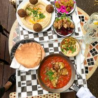 2 dishes - Shakshouka with aubergine, Hummus & falafel plate at Mezze in Warsaw