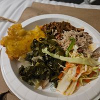 A plate with several dishes that I sampled: pinto rice, spicy slaw, greens, tostones, and barbacoa ste'k. Portions we received were much larger! at PurelyPlant in Atlanta