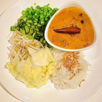 Small portions vermicelli with lots of mung bean coconut curry peanut sauce with a hair on my plate. 🥴  at Satdha Plant Based Thai Kitchen in Santa Monica