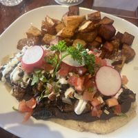 Tlacayo vegan option- double corn tortilla with beans, mushrooms seasoned pastor style with pico de gallo, vegan cheese and vegan sour cream and home fries as a side   at Camaleon in Toronto