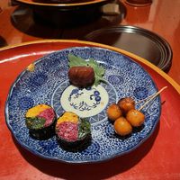 Beautiful rolls of chrysanthemum petals and spinach, grilled small potatoes, and marinated chestnut   at Itosho in Tokyo