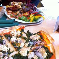 Antipasto plate (rear) and tofu and spinach pflammkuchen (front). at Veganz - Munich in Munich