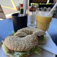 Vegan bagel with a orange smoothie   at Ground Art Caffe in Cape Town
