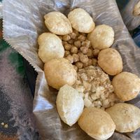 Forgot what this is but you make a hole, fill it, and add the tamarind and lime sauce. Delicious!  at Bombay Food Junkies in St Louis