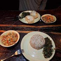 Vegan chicken stew, accompanied by sorghum, spinach, dumplings, and bean leaves. at Planet Culture Café in Maun