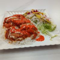 the Persian eggplant dish with rice & salad with optional drizzle of tahini & hot sauce at Ariyana in Peterborough