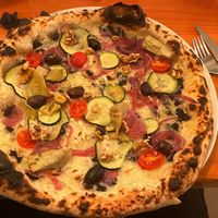 vegan pizza! It had truffle oil, pickled onion and artichoke, olives, tomato and little tomatoes. I added extra vegan cheese.  at UNA PIZZERIA in Vilassar De Mar
