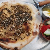 Zaatar flatbread with vegan yogurt dip and small salad at Beirutina in Sevilla
