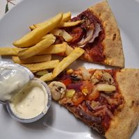 Pizza, fries and plant based garlic and herb dip at Domino's Pizza in Longford