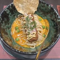 Panang curry with ramen noodles and a faux crab cake  at Vegan Pranakhon in Bangkok