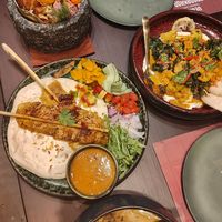 Satay 'chicken' skewers w pitta & salad; curried ramen w dumplings at Vegan Pranakhon in Bangkok