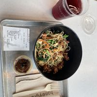Whole wheat noodles topped with tofu, spinach, carrots, fresh green beans, pecans, and a sesame garlic sauce. Black cherry drink on the side    at honeygrow in Toms River