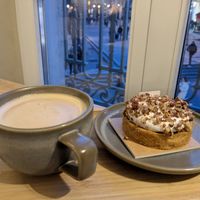Cafe au lait with Cancan and view of Fontaine des Innocents out window #Veganuary at Land & Monkeys - Les Halles in Paris