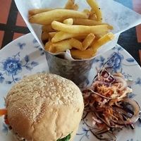 Burger and chips with salad. at The Cosy Club in Cardiff