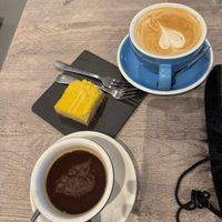 Americano, oat latte and vegan lemon cheesecake at Cortado in Delft