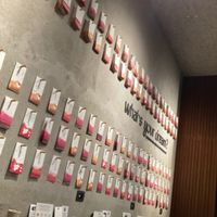 The wall with all the wishes card hanging, the table towards the wall  at Yume Ramen in Rimini