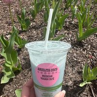 Vegan Cielito Lindo (Cute Little Sky) pineapple, banana, blue spirulina smoothie with no refined sugars! It gets its beautiful blue color naturally from the blue spirulina. Plus the cup & straw are compostable  at Abuelita Coco in Oak Lawn