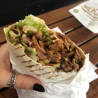 happy vegan eating a vegan döner wrap aka dürüm  at Vegitat - Klybeckstrasse in Basel
