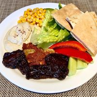 Hummus, muhammra, salad and bread  at Taybeh Restaurant in Aqaba