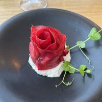 Marinated beetroot petal rose, filled with watercress and cashew pesto, on a delicate almond cream  at Berro Bistrot in Gran Canaria
