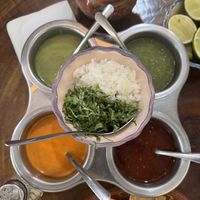 4 salsas, onions, cilantro and lime as toppings for tacos   at Tacos Sonorita Olas Atlas in Puerto Vallarta