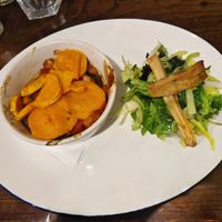 Main: Spicy butterbean, red pepper and smoky tomato hotpot, with wilted greens and roast parsnips at The Bull's Head in Macclesfield